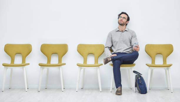 istock Shot of a young man day dreaming while waiting to be interviewed 1372736238