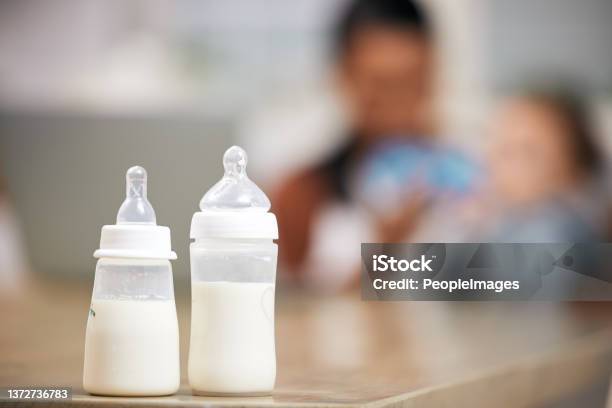 A Defocused Shot Of A Mother Feeding Her Baby Boy At Home Stock Photo - Download Image Now