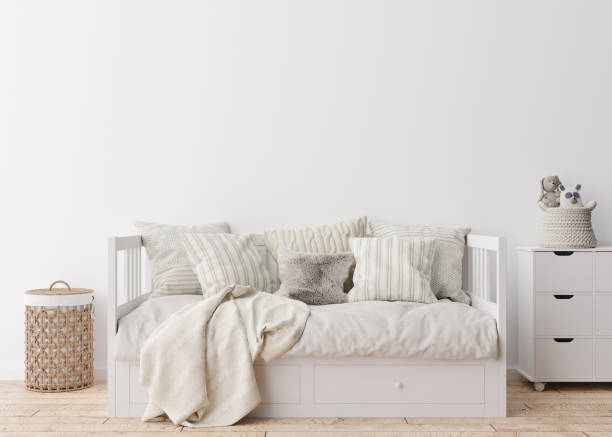 istock Empty white wall in modern child room. Mock up interior in scandinavian style. Free, copy space for your picture, poster. Bed, rattan baskets, toy. Cozy room for kids. 3D rendering. 1372738071