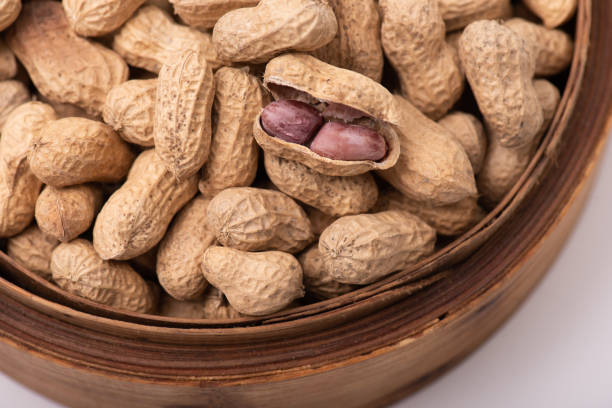 The peeled peanuts are placed among many peanuts.