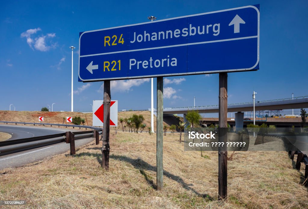 Road signs indicating the direction of travel to Pretoria and Johannesburg at the fork in the road. Road signs indicating the direction of travel to Pretoria and Johannesburg at the fork in the road. Road sign indicating the direction of travel by car from Tambo Airport. South Africa, Pretoria Stock Photo
