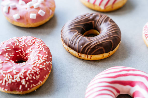 istock Multicolored donuts on a concrete background. View from above. 1372741317