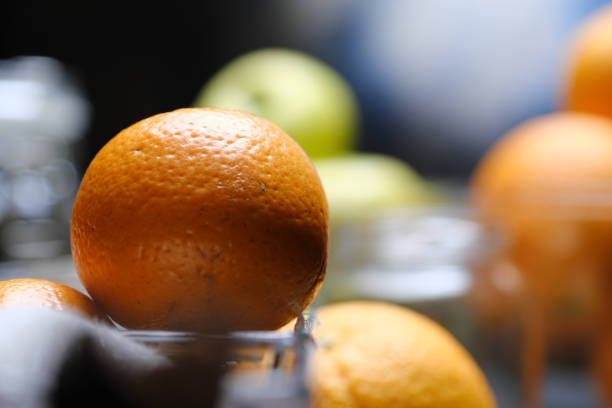 Unrecognizable person is preparing homemade marmalade with oranges and apples
