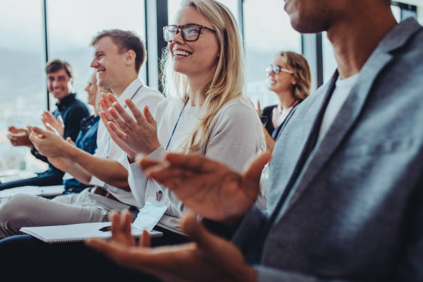 business professionals applauding at a seminar - business conference imagens e fotografias de stock