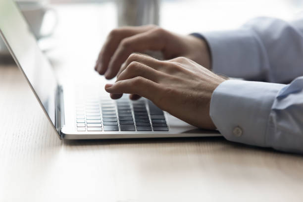 istock Close up male hands typing on modern laptop keyboard 1372744151