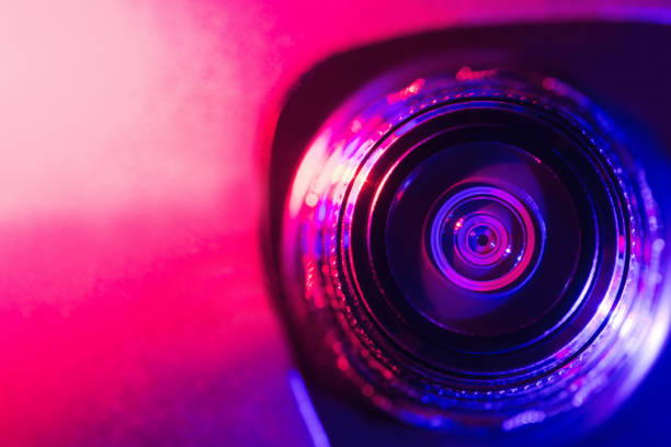 istock Camera lens with purple and pink backlight. Optics. Cyberpunk style 1372744336