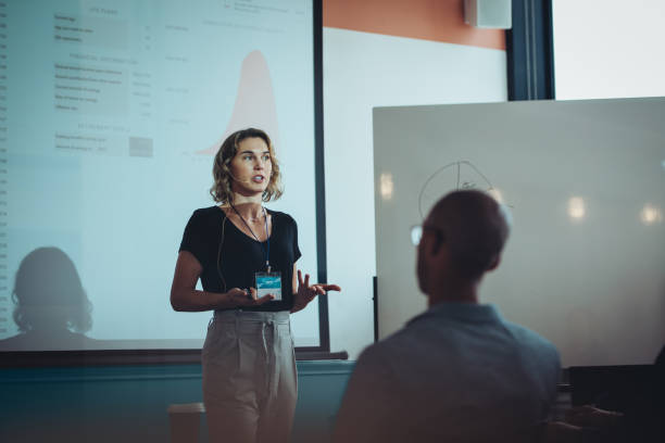 istock Woman addressing a business conference 1372745244