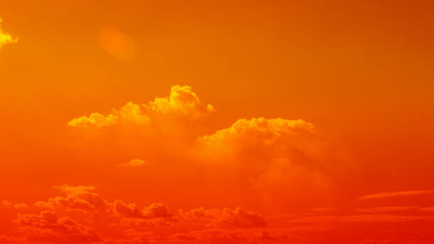 istock orange sky Clouds moving away rolling colorful sunset light dramatic clouds 1372745641
