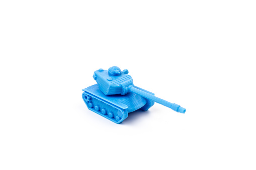Blue Plastic Tank Toy Side View Isolated on White Background. Little plastic ABS model. Blue filament. Objects printed by 3d printer Isolated on white background.