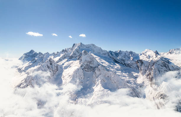 istock Mountain range above the clouds and clear sky 1372748525