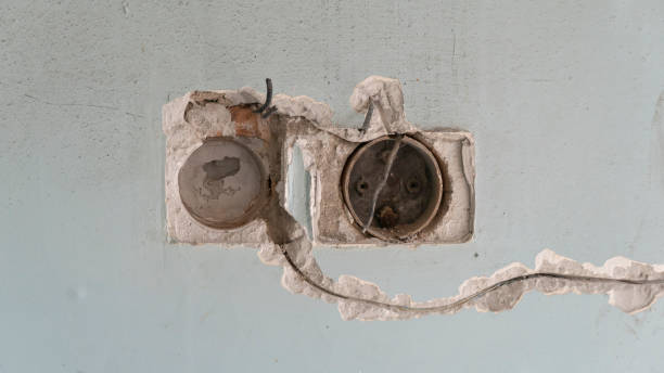 istock old switch on a concrete wall. abandoned house 1372748737