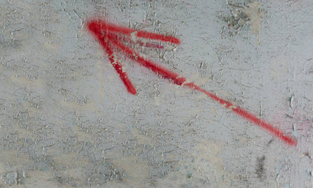 istock drawn arrow on the old wall in the cracks. old plaster. cracks on the wall 1372749044