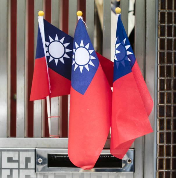Three Taiwanese flags and a mailbox in Taipei, Taiwan, Asia