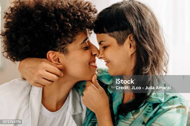 Playful Lesbian Couple Touching Their Noses Together Stock Photo - Download Image Now