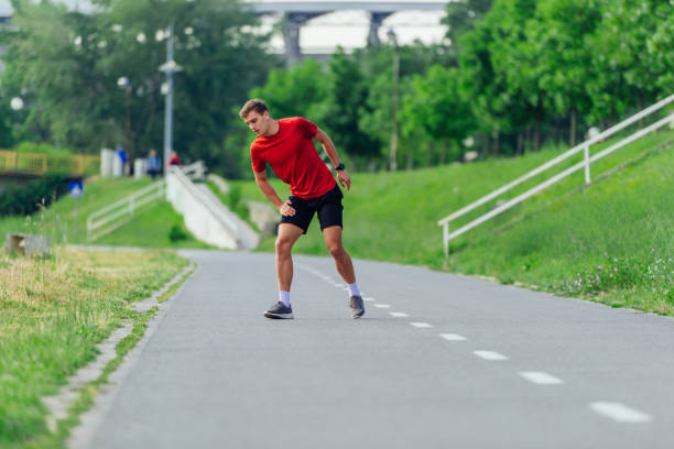 istock Handsome young man stretching and warming up before for morning workout  in the park 1372755977
