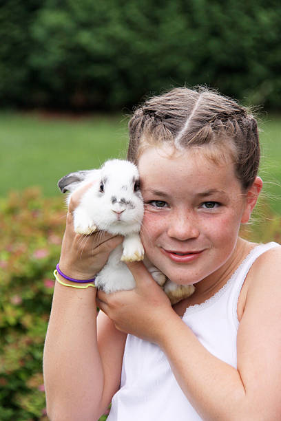 istock child with braids holding baby rabbit 137275667