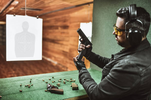 istock Smiling Male Shooter Showing How To Properly Load Gun 1372757425