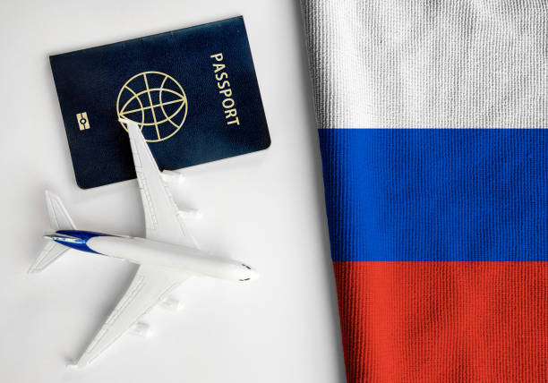Flag of Russia with passport and toy airplane stock photo