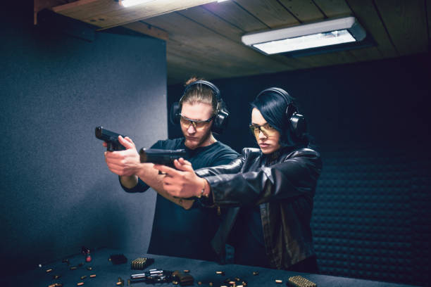 istock Firearms Instructor Explaining Gun Grip To Female Student 1372757845