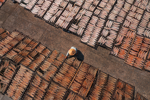 Drone view of drying dried fish and squid - a traditional food of many fishing village in Vietnamese - in Hon Ro dock, Nha Trang city, Khanh Hoa province, central Vietnam