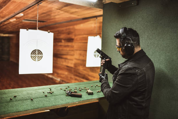 istock Focused Male Loading Magazine Into Pistol Before Trying It Out On Gun Range 1372758282