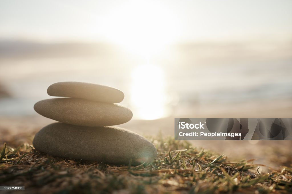 Closeup shot of a stack of stones on the beach May peace be with you Mindfulness Stock Photo