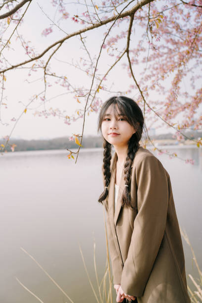 istock Asian beautiful girl under cherry tree 1372758904