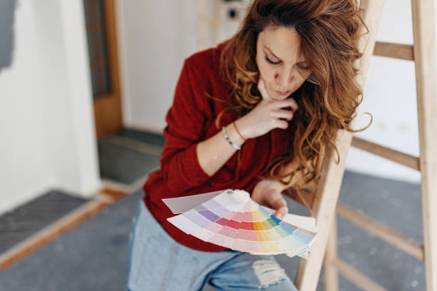 istock Young  woman painting  room 1372761107