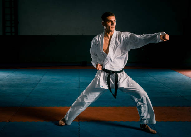 istock Male karate fighter in white kimono training 1372761325