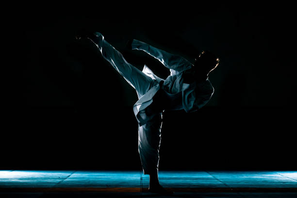 istock Young man is practicing martial arts in sport gym 1372761336
