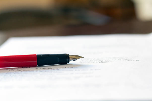istock Red fountain pen lying on the paper 1372769625