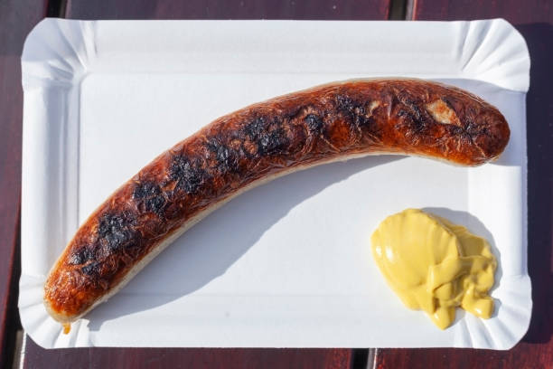 Thuringian Rostbratwurst with mustard on a paper plate, Germany, Europe