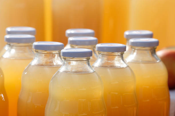 Glass bottles filled with orange fruit juice