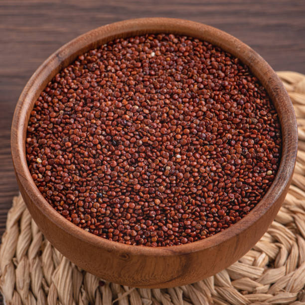 istock Organic red quinoa in a bowl on wooden table background. 1372771599