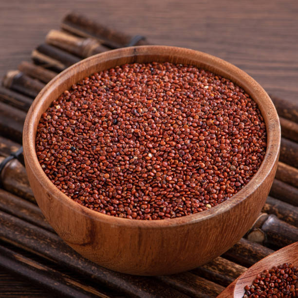 istock Organic red quinoa in a bowl on wooden table background. 1372772346