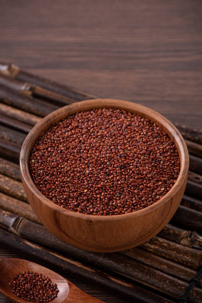 istock Organic red quinoa in a bowl on wooden table background. 1372772348