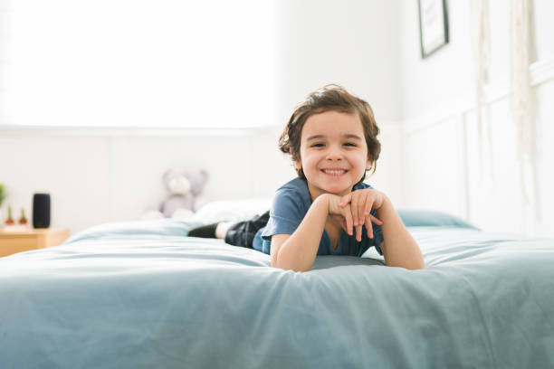 istock Happy kid lying on his comfy bed 1372777221