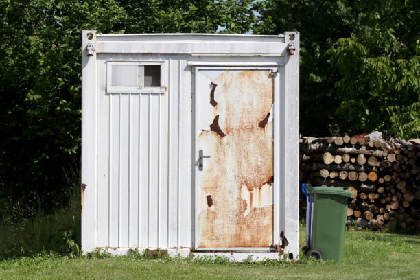 istock Front view of white old abandoned industrial shipping container converted into storage space with rusted doors in front 1372777905