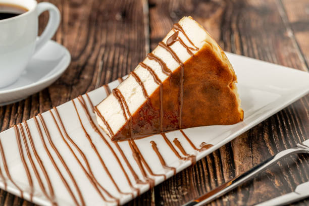 istock Sliced san sebastian cheesecake with coffee on wooden table 1372780964