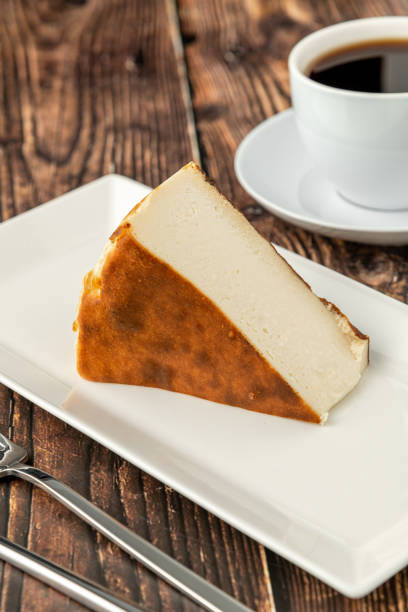 istock Sliced san sebastian cheesecake with coffee on wooden table 1372781006