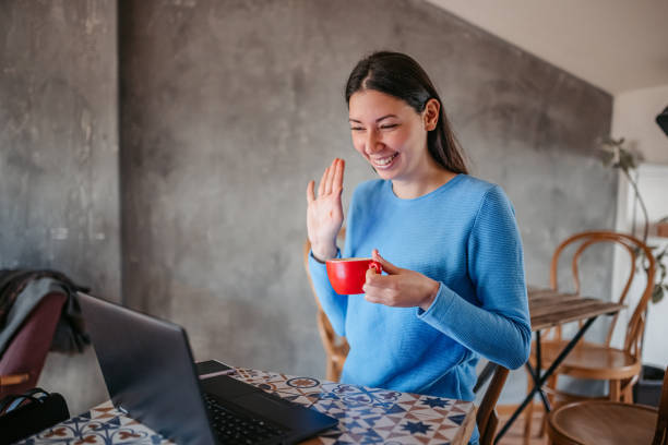istock Woman doing a video call while sitting in a coffeeshop 1372781194