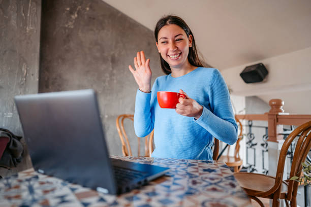 istock Woman doing a video call while sitting in a coffeeshop 1372781242