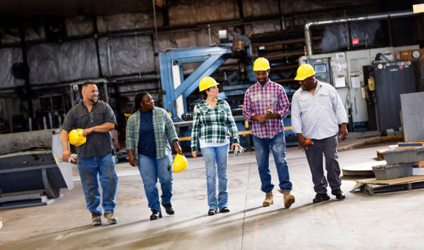 istock Multiracial workers walking in metal fabrication shop 1372782595