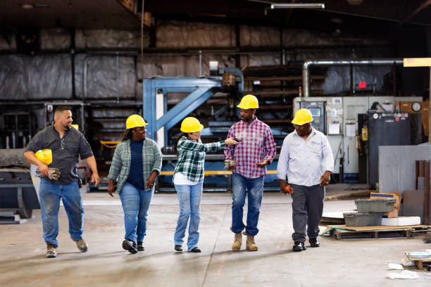 istock Multiracial workers walking in metal fabrication shop 1372782620