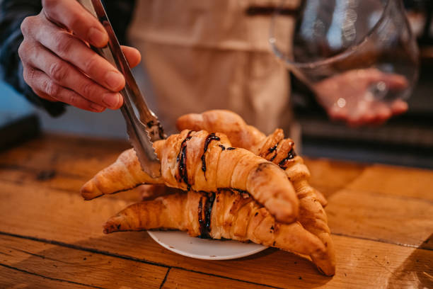 istock Barista serving freshly baked croissants 1372784231