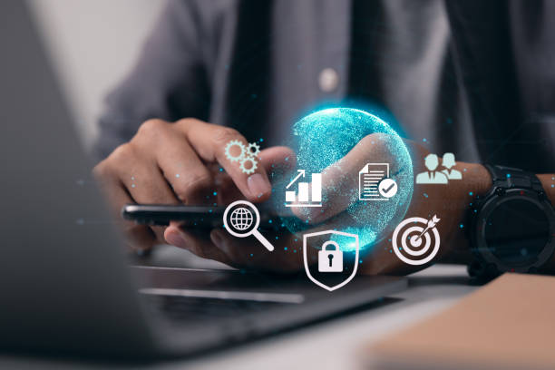 istock Businessman interacts with his smartphone while holding it up to the digital internet world. Digital networking and business on the Internet technology. 1372785741