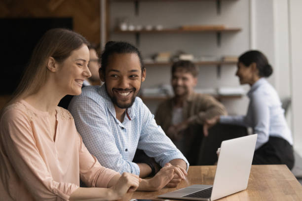 istock Multi racial colleagues talking laughing sit in modern coworking space 1372787225