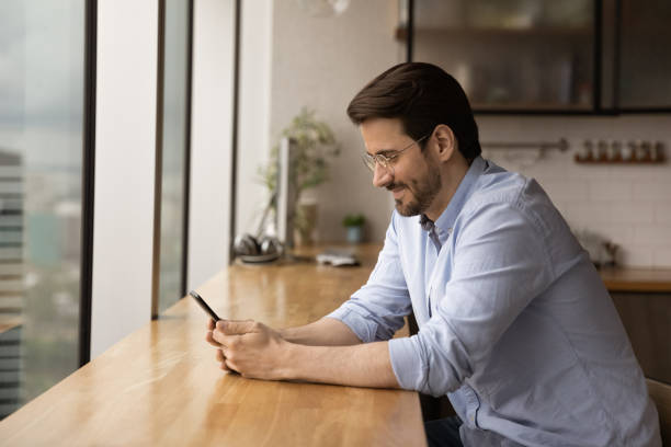 istock Guy sit indoor holding smartphone communicate in social networks 1372788114