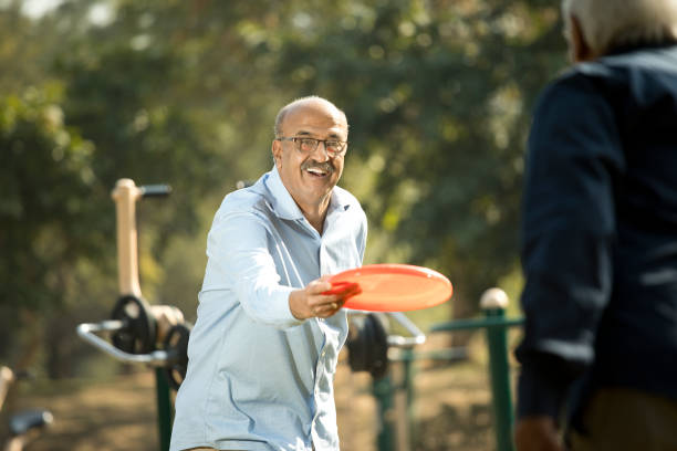 istock Senior men playing frisbee in the park 1372788962