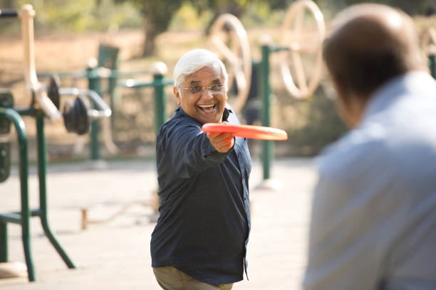 istock Senior men playing frisbee in the park 1372788990